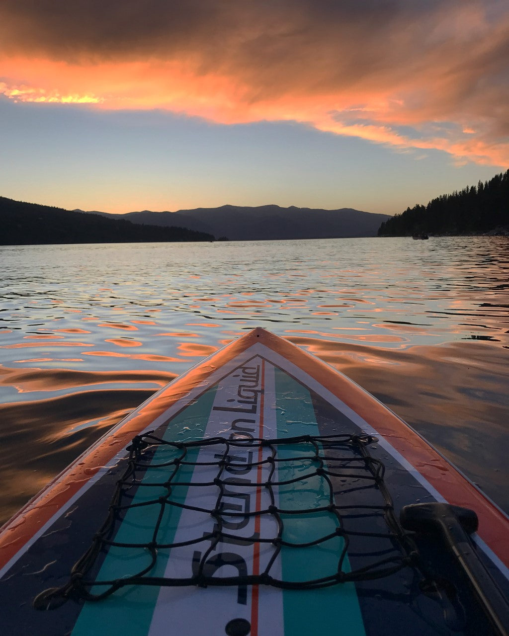 Sunset on a lake with stand up paddle board by Stand on Liquid