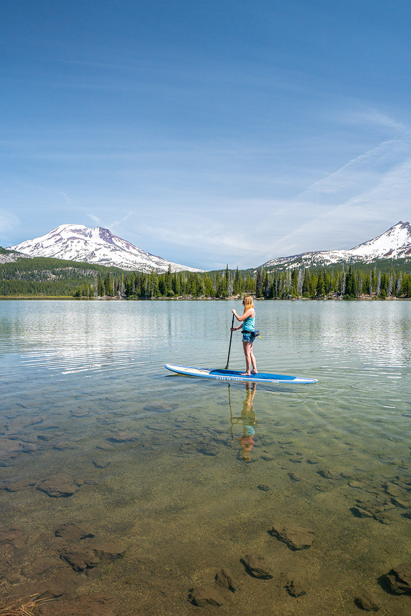 Woman paddling Quest stand up paddle board by Stand on Liquid at Sparks Lake Oregon with adjustable paddle