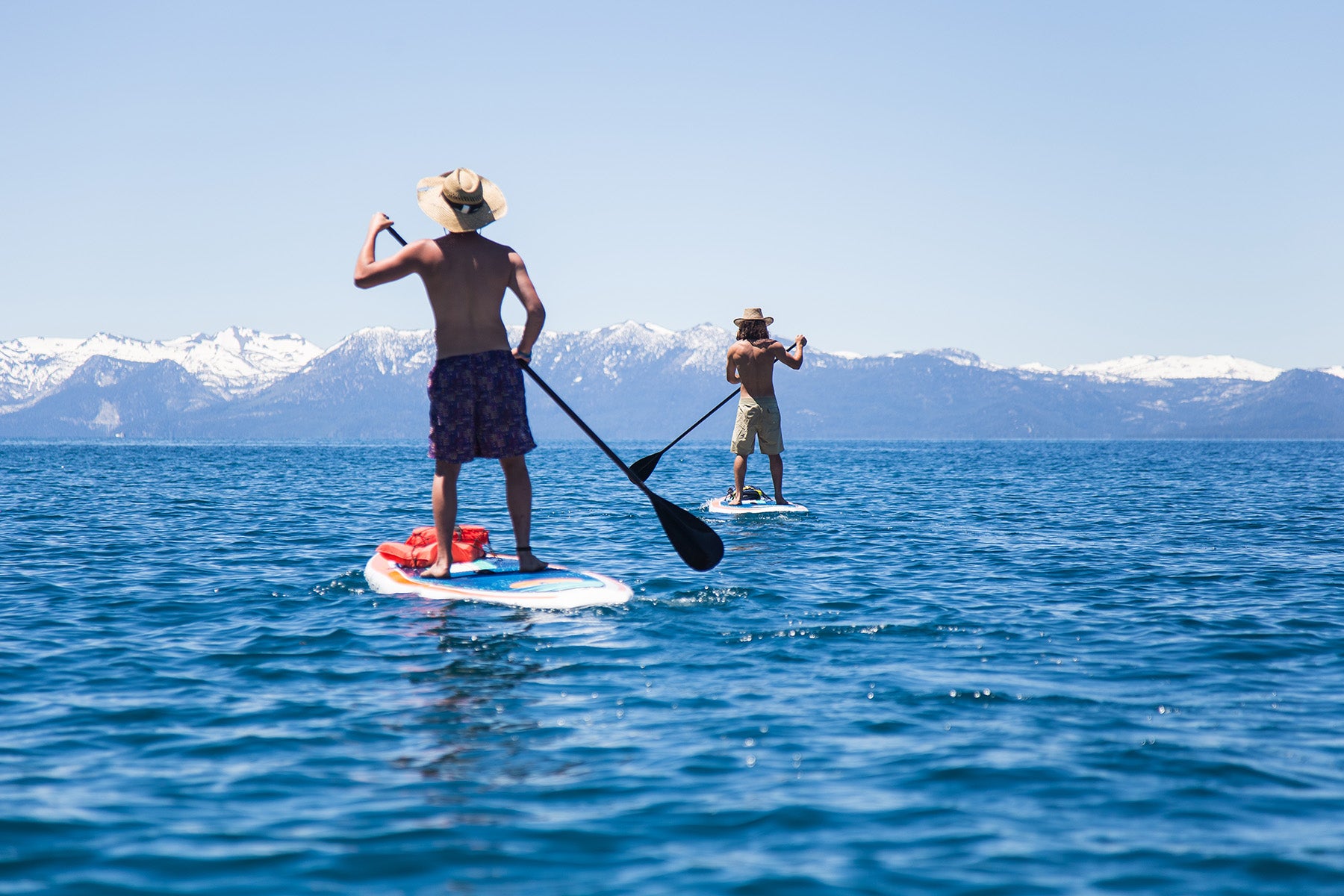 Enjoying sunshine on a lake with Stand on Liquid stand up paddle boards and fixed carbon paddles