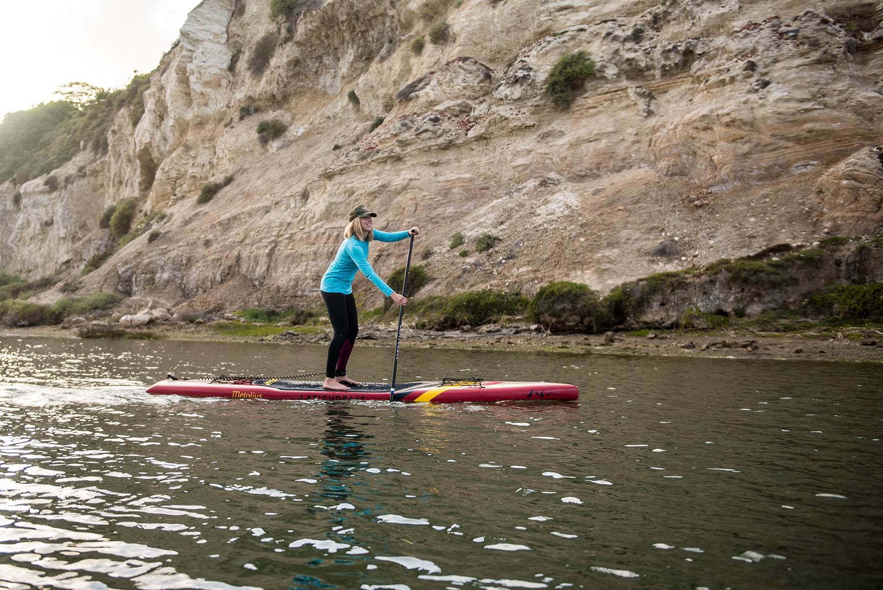 Woman paddling Stand on Liquid stand up paddleboard with fixed paddle